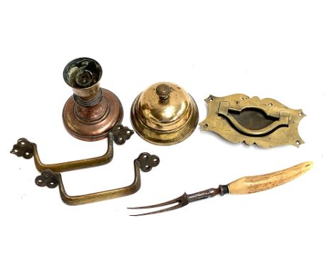 An antique brass service bell, 11.5cmD; copper candlestick holder, 12.5cmH; brass handles and a bone handled toasting fork 