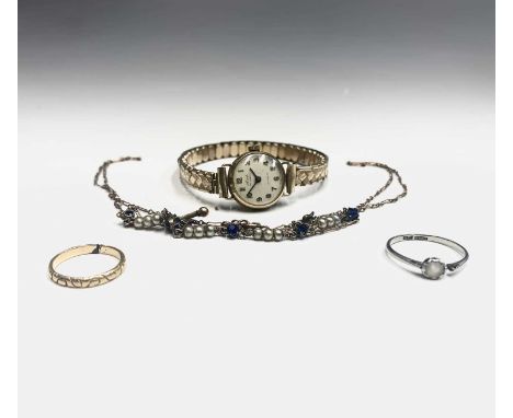 A 9ct gold necklace, a gold band and an 18ct white gold ring and a ladies gold cased wristwatch