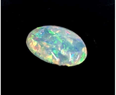 An unmounted oval opal weighing 1.29 cts, 8mm x 10mm.Condition report: This is a solid opal. No sign of treatment