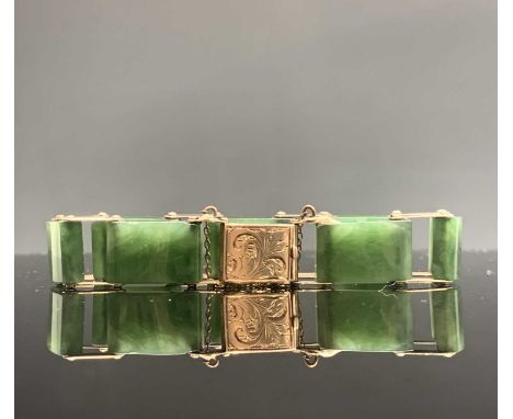 A 9ct gold and jade link bracelet with chased clasp