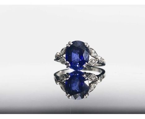 A fine art deco sapphire ring set in platinum the stone of 3.75ct is flanked by trios of old cut diamonds.Approx size: O - O1