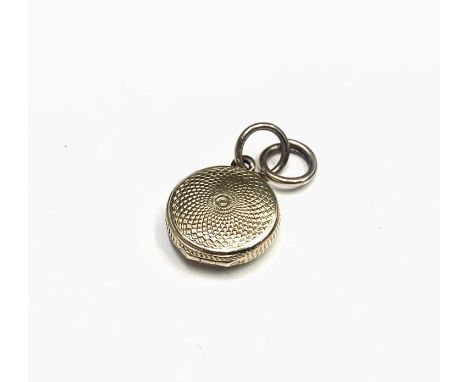 A Victorian tiny gold locket with swirl engine turning Dia 13mm