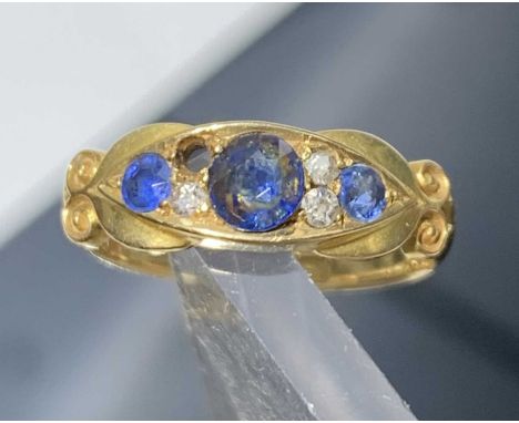 A Victorian 18ct gold ring set three sapphires and three (of four) diamonds.Approx size: M-M1/2