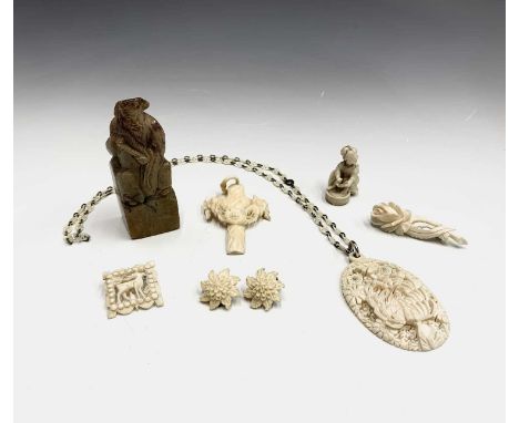 A carved ivory pendant, a netsuke other carvings and a soapstone seal