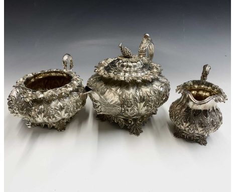 A remarkably ornate Irish tea service by R W Smith, Dublin 1837, the teapot with bunch of grapes finial and fluted melon form