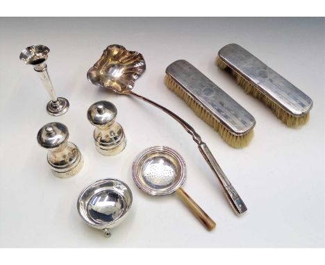A pair of modern silver salt and pepper mills, a silver spill and two silver mounted brushes together with a large epns ladle