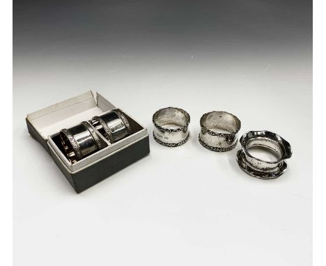 Two pairs of silver napkin rings and a fifth silver napkin ring 4.5oz