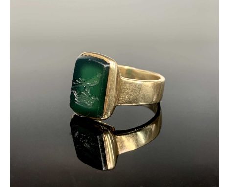 A 9ct gold signet ring, the finely carved green rectangular intaglio with a bird within a crown. Hallmarked Birmingham 1910, 