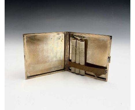 A 9ct gold cigarette case by P G Dodd, Cornhill, London with engine turned decoration and Greek key borders. The case bears a