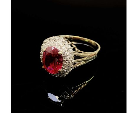 A gold oval diamond and red stone cluster ringCondition report: Size W1/2 10.19 x 8.08 depth 4.7mm