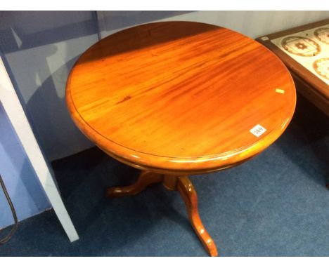 A reproduction mahogany tripod table
