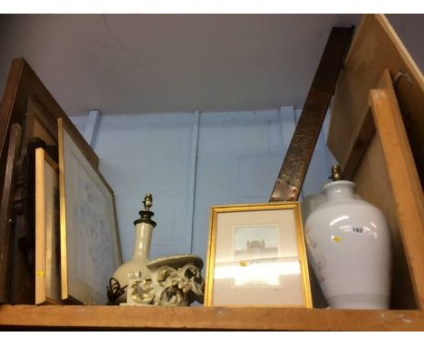 A shelf of pictures, lamps and a fender