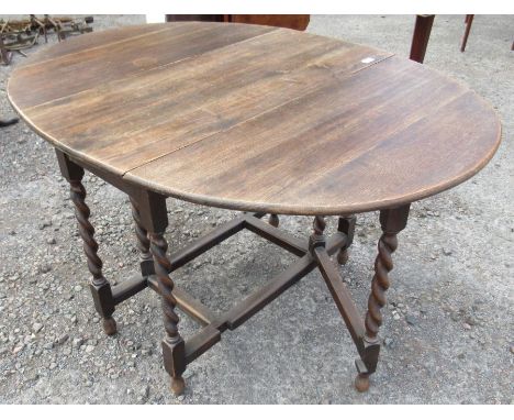 An oak gate leg table, with barley twist legs, height 30ins, width 38ins