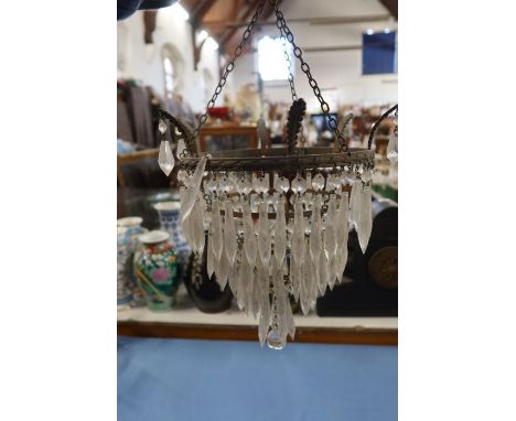 A three tier light fitting with clear droppers