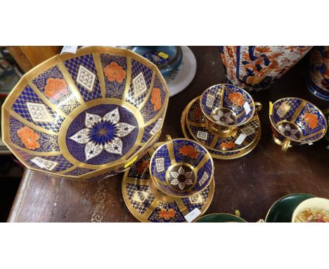 A Caverswall porcelain imari bowl, af, together with three Caverswall imari pattern cups and saucers