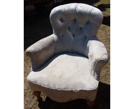 A Victorian button back upholstered nursing chair, raised on short gilt legs, with carved decoration