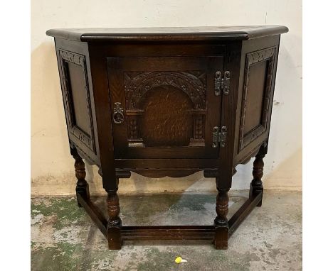 An oak three panel side cabinet with central carved panel (H71cm W81cm D33cm)