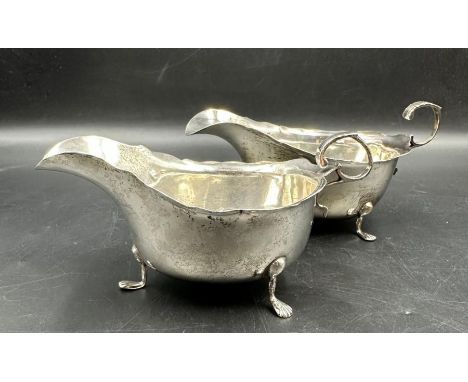 A pair of silver sauce boats on three feet, approximate total weight 187g, hallmarked by George Nathan and  Ridley Hayes for 