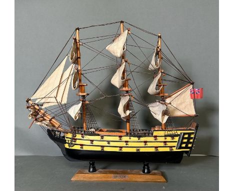 A wooden scale model of HMS Victory on plinth 