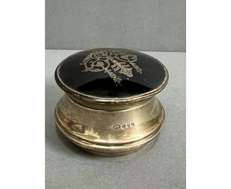 A Sterling silver and tortoiseshell powder box with scrolled motif on lid. Hallmarked London 