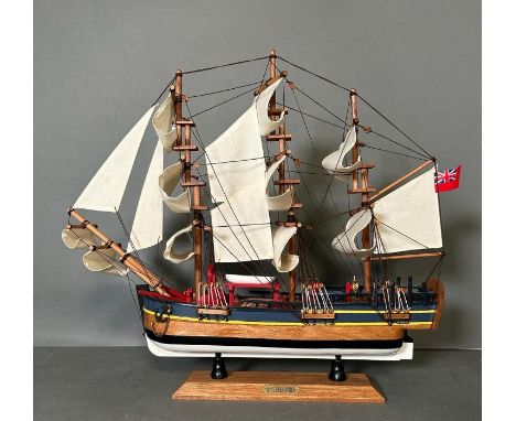 A wooden scale model of HMS Endeavour on plinth 