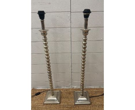A pair of  contemporary metal bobbin style tall light 
