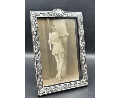 A good Art Nouveau silver embossed photograph frame, Birmingham 1901, together with period 1915 sepia photograph of a saucy l