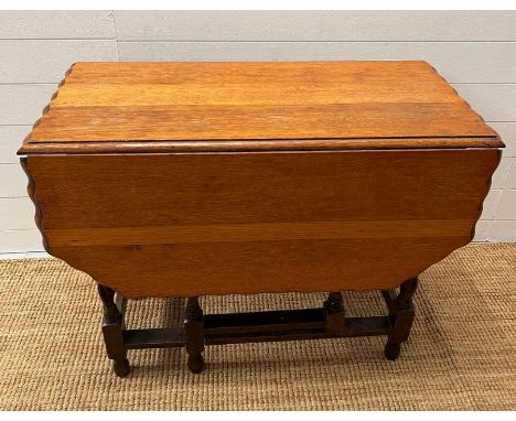 A gate leg table with wave edge 