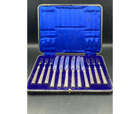 A boxed set of six silver handled fruit knives and forks by William Hutton &amp; Sons Ltd, hallmarked for Sheffield 1912.