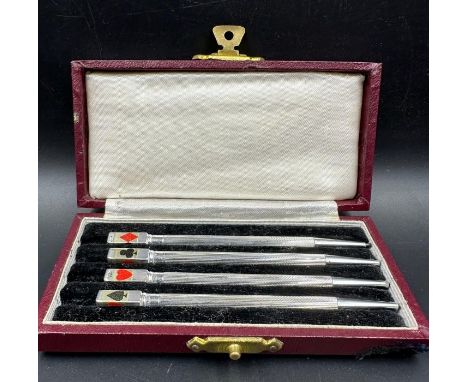 A cased set of 4 Art Deco silver and enamel bridge pencil markers, c.1930, engine turned in fitted Morocco case.