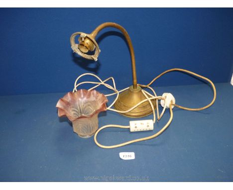 A brass flexi Reading Light with a cranberry fluted glass shade.