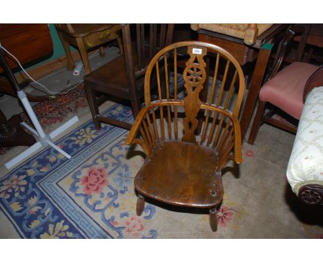 An appealing Child's bentwood Armchair with central wheelback splat and stick back detail to either side, solid elm seat, 31"