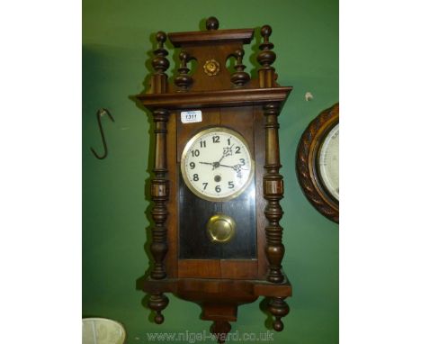 A wall Clock with turned details to sides.