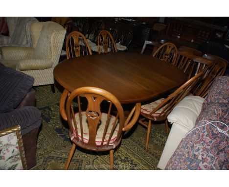 An Ercol Elm pull-out Dining Table, 65 1/2" fully extended x 45" wide on single pedestal base with four supports and a set of