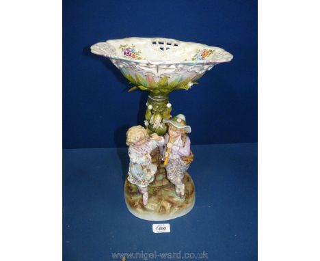 A table centrepiece with Meissen mark, impressed shield to base and no. 7002, featuring two young children at the base of a t