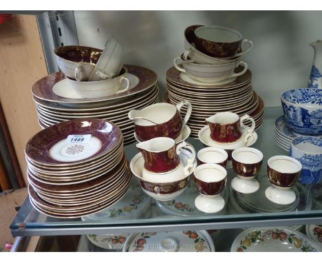 A quantity of Midwinter dinnerware including plates, soup cups, etc.in dark red and gold pattern.