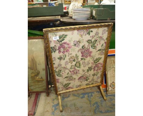 A gilt framed metamorphic firescreen with fabric under glass panel, converts into a small table.