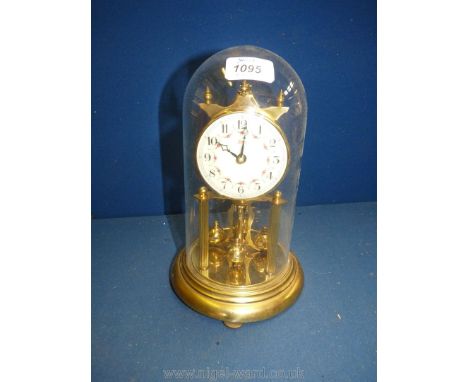 A brass Anniversary clock under dome, with Arabic numerals, 10'' tall.
