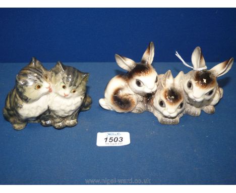 A Beswick figure of two kittens together with a Goebel figure of three rabbits.