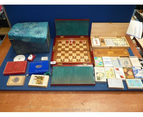 A quantity of playing cards, travelling chess board (some pieces missing), two cribbage boards, Dominoes etc.