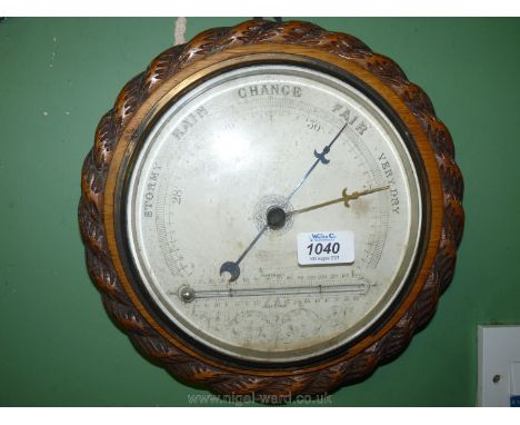 A rope twist design wooden frame barometer/thermometer, the thermometer unusually positioned in horizontal position.