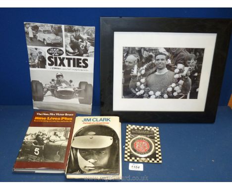 A framed photograph of Jim Clark, a 'Portrait of a Great Driver' by Jim Clark, an Austin Healey woven cloth badge, etc.