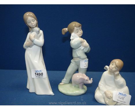 Three Nao figures of girls as Angel, holding lamb and holding puppy.