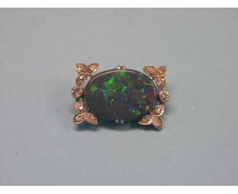 A diamond and opal doublet brooch, fourteen small diamonds, large black opal doublet, 3 x 2cm.