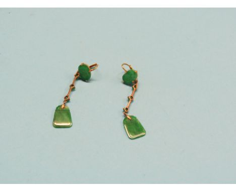 A pair of jade and yellow metal ear-drops, jade with incised detail
