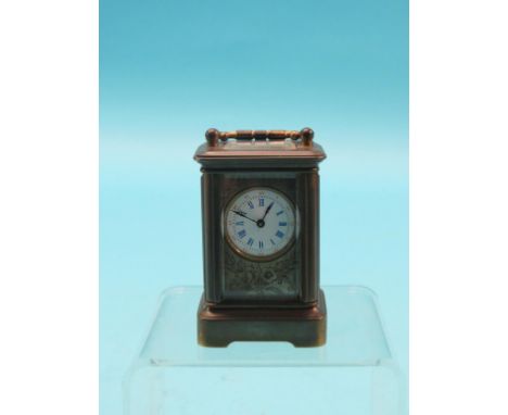 A miniature brass carriage clock, enamelled dial with floral engraving, timepiece movement, with two keys, 3.75in. - inoperat