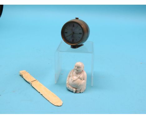 A carved ivory seated Buddha, 3in., an ivory paperknife with carved clenched fist finial, 8in. and a Swiza novelty brass barr