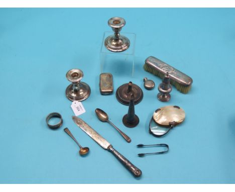 Small silverware, including scent bottle, pair of candlesticks, white metal cigarette case, etc., as viewed 