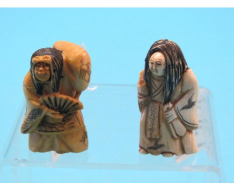 Two ivory netsuke, each a robed character with novelty revolving faces, signed, 2in. Shipping arrangements limited.  Buyer be