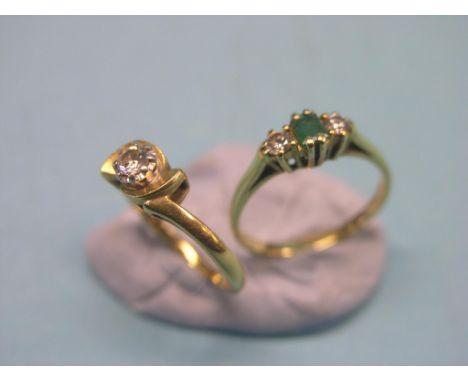 Two 18ct. gold rings, claw-set emerald and two diamonds, and a diamond solitaire, both size K/L 